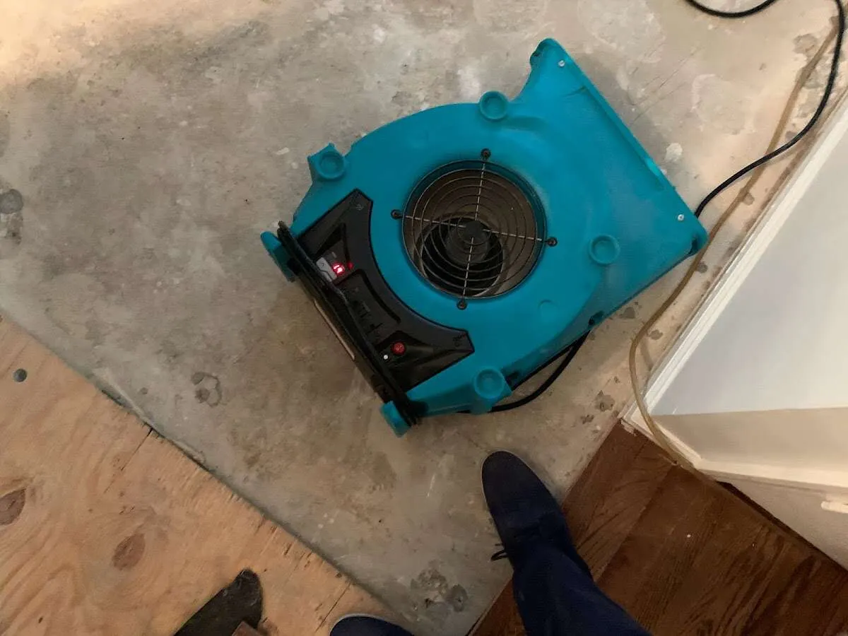 Air mover drying subfloor during Commercial Water Damage Restoration in West Haverstraw